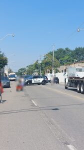 A cop car blocking traffic behind the group